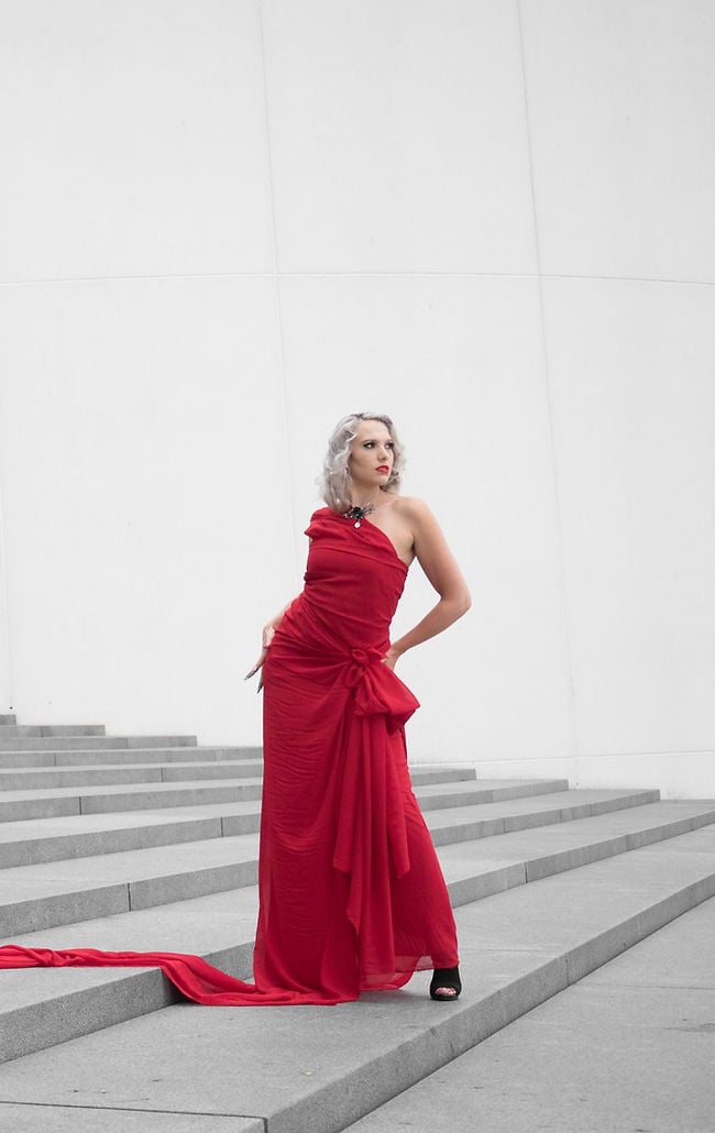 Model in red dress on wide stone steps